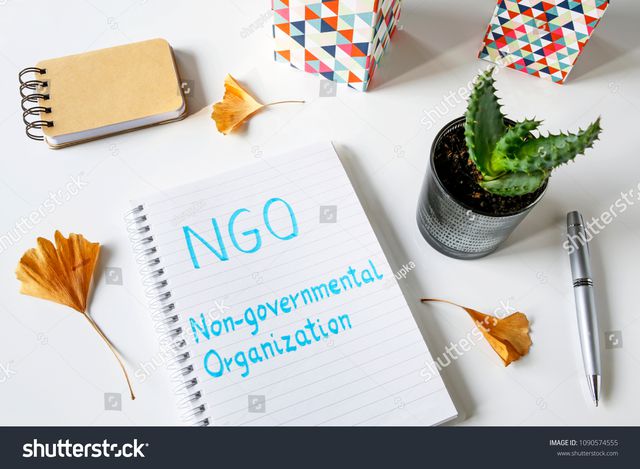 stock-photo-ngo-non-governmental-organization-written-in-notebook-on-white-table-1090574555.jpg